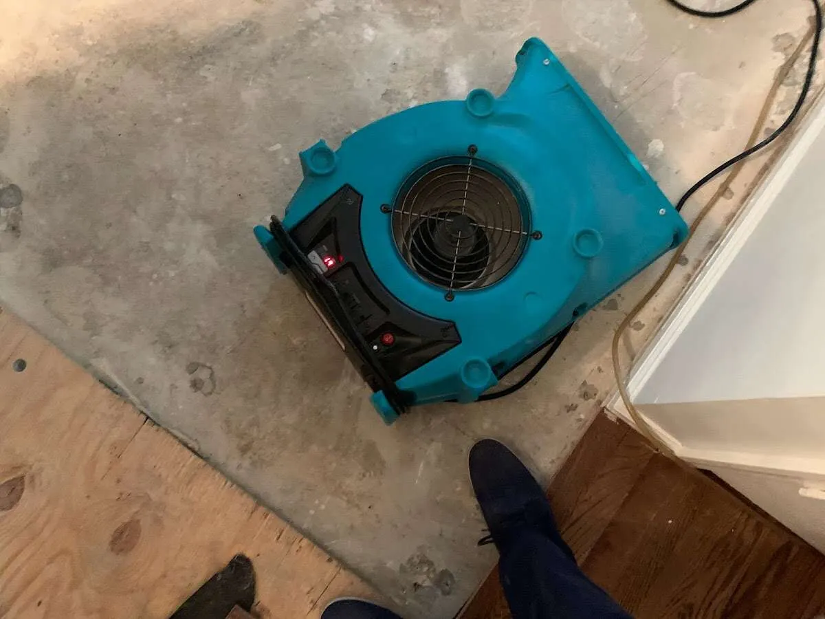Air mover drying subfloor during Commercial Water Damage Restoration in Doraville